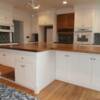 White and stained maple kitchen cabinets with stained maple island top