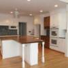 White and stained maple cabinets; bead board doors and posts